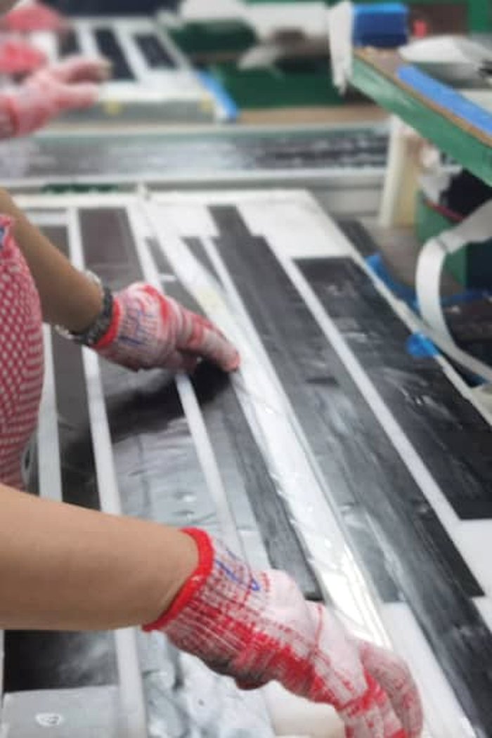 Manual carbon-composite layup on the production bench